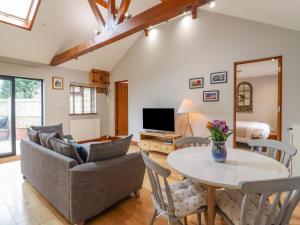 a living room with a couch and a table at Beulah Cottage Annexe in Ashford