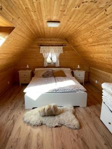 a bedroom with a bed and a wooden ceiling at Roubenka 1818 in Všelibice