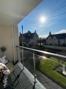 a balcony with a view of a yard at Dalriach Apartment in Oban