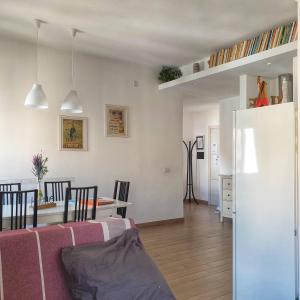 a living room and dining room with a pink couch at BecoHouse in Rome