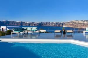 a swimming pool with a view of the water at CAPE 9 Villas & Suites in Akrotiri