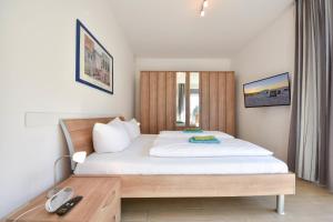 En eller flere senge i et værelse på Quartier II Wohnung 3