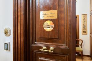 a wooden door with a sign on it at Fabrizio's Rooms in Rome