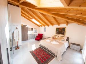 a bedroom with a bed and a red chair at VILLA SILVIA-by Home Sitter Como in Como