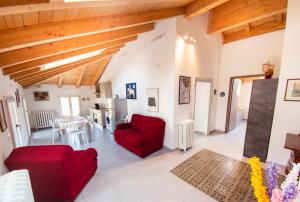 a living room with red chairs and a table at VILLA SILVIA-by Home Sitter Como in Como