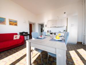 a living room with a table and a red couch at VILLA SILVIA-by Home Sitter Como in Como