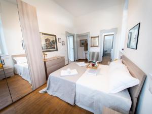 a room with two beds and a mirror at VILLA SILVIA-by Home Sitter Como in Como