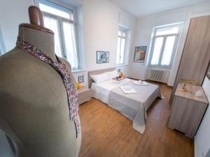 a room with a bed with a tie on it at VILLA SILVIA-by Home Sitter Como in Como