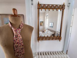 a tie hanging on a mannequin in front of a mirror at VILLA SILVIA-by Home Sitter Como in Como