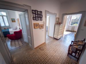 a hallway with a room with a bed and a red chair at VILLA SILVIA-by Home Sitter Como in Como