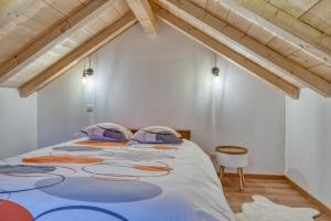 a bedroom with a large bed in a attic at Mazot savoyard situé à 25 kms de CHAMONIX in Saint-Gervais-les-Bains