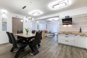 a kitchen and dining room with a table and chairs at Reset Apartments in Kranjska Gora