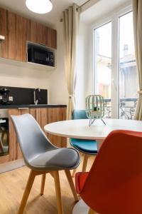 cocina y comedor con mesa y sillas en Instant de douceur au pied des Thermes, en Allevard