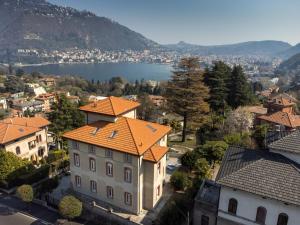 an aerial view of a town with a large building with an orange roof at VILLA SILVIA-by Home Sitter Como in Como