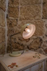 a lamp sitting on top of a wooden table at Le casette di Nardò in Nardò