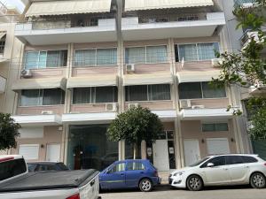a building with cars parked in front of it at City House 3 in Kalamata