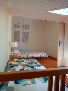 a bedroom with a bed and a lamp in it at Hakuna Matata Hostel in Zambujeira do Mar