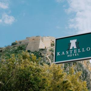 a sign in front of a castle on a hill at Kastello Hotel in Nafplio