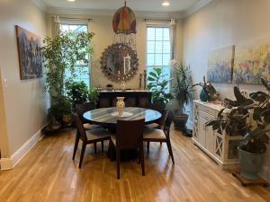 a dining room with a table and chairs and plants at 5BRwithBand&Piano setup Private Gym Theater&Entry at Cherry Hill in Cherry Hill