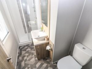 a small bathroom with a toilet and a sink at 69 The Paddocks in Carmarthen +19 photos