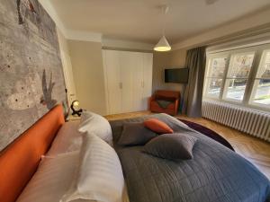 a bedroom with a bed with pillows on it at Orange Flat by GrazRentals highest standard & free parking in Graz