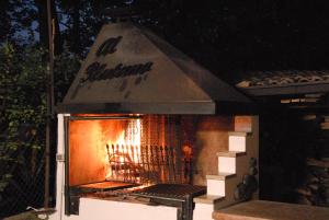 a grill with a fire inside of it at Albergo Al Platano in Caprino Veronese