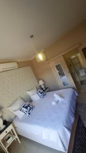 a bedroom with two beds with white sheets and pillows at Black Diamond B&B Guesthouse in Upington