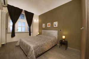 a bedroom with a large bed and a window at La Corte in Alba