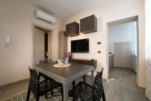 a dining room with a table and chairs at La Corte in Alba