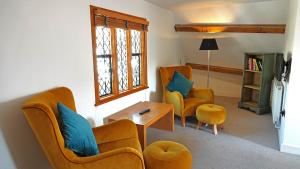 a living room with two chairs and a table at Merchants Rise in Dartmouth