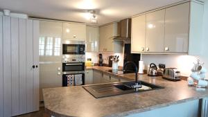 a kitchen with white cabinets and a counter top at Merchants Rise in Dartmouth