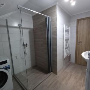 a bathroom with a shower and a toilet and a sink at Receptiva BL in Banja Luka