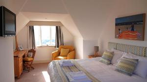 a bedroom with a bed and a desk and a television at The Lookout at Lauriston in Dartmouth