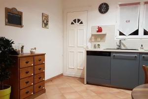 a kitchen with a sink and a dishwasher at Les oliviers de Murateddu (Maison individuelle) in Porto-Vecchio