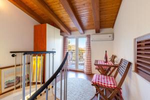 a room with a staircase and a table and chairs at Apartman Dijana in Trogir