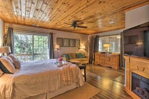 a bedroom with a bed and a flat screen tv at Remodeled Crestline Retreat Walk to Lake Gregory! in Crestline