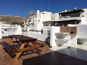 a balcony with a toilet and a picnic table at La Martinica in Agua Amarga