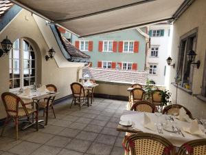 an outdoor patio with tables and chairs and buildings at Zunfthaus zur Rebleuten in Chur