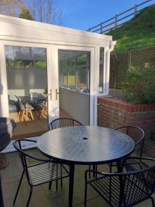 a table and chairs sitting on a patio at Stylish 2 bed apartment next to the Norfolk Broads in Coltishall