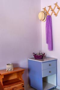 a room with a blue dresser next to a table at Anemos Studios & Apartments in Poros