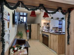 a kitchen with christmas lights and christmas decorations at Dworek w Płoni in Szczecin-Płonia