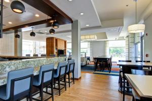a bar in a restaurant with chairs and tables at Hyatt House Naperville/Warrenville in Warrenville