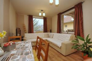 a living room with a couch and a table at Bodza apartman in Gyula