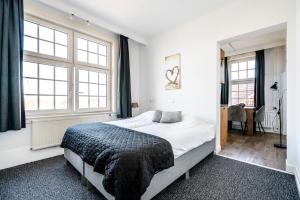 Кровать или кровати в номере Duinhotel Haga