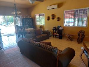 a living room with a couch and chairs in it at BEAUTIFUL HOUSE IN LAS UVAS SAN CARLOS, PANAMA WITH FRUIT TREES -SWIMMING POOL in Las Uvas