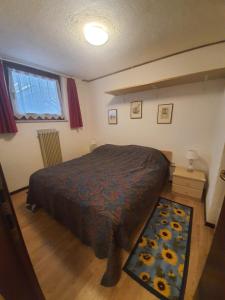 A bed or beds in a room at Apartment San Giacomo - Brentonico