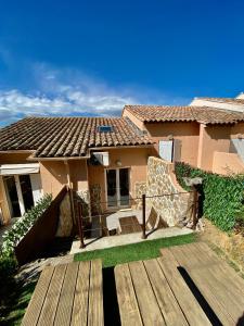 a house with a wooden deck in front of it at Jolie maison Golfe de Saint-Tropez in Cogolin