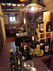 a bunch of wine bottles on a table in a restaurant at Locanda Cantina Di Bacco in San Marino