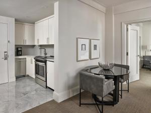 a kitchen with a table and a dining room at AKA Central Park in New York