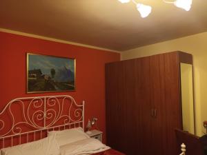 a bedroom with a bed and a painting on the wall at Locanda Cantina Di Bacco in San Marino